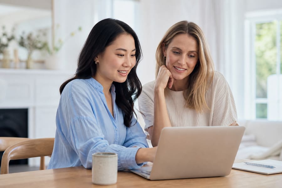 Two people reviewing household finances on a laptop